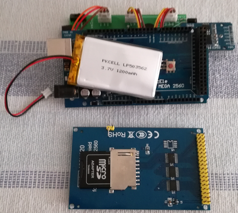 Place the battery between the Arduino board and the TFT screen